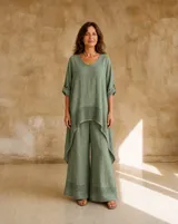 Blusa verde seco de lino, con cuello redondo, mangas tres cuartos con presilla y dobladillo asimétrico con detalle de tejido calado.