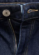 Jeans mom-fit de tiro alto color azul oscuro, con cinco bolsillos, presillas para cinturón y cierre de cremallera y botón.