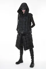Chaleco puffer negro con diseño de cuadros, capucha y bolsillos laterales. Tiene cierre central y un cierre horizontal a la altura de la cadera que permite quitar la parte inferior, modificando el largo del chaleco.
