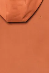 Sudadera cropped fit con capucha y cierre frontal de cremallera, confeccionada en tejido de algodón en color naranja. Cuenta con bolsillos frontales tipo canguro y efecto lavado.