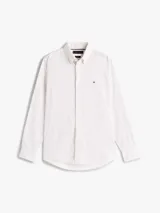 Camisa de manga larga confeccionada en algodón regenerativo con tejido de pana. Presenta un diseño estampado de pequeños motivos geométricos, cuello clásico con botones y cierre frontal abotonado. Incluye el logo de la marca bordado en el pecho.