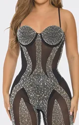 Body entero de corte ajustado confeccionado en tejido mesh transparente. Presenta un diseño con copas estructuradas y aplicaciones de pedrería brillante distribuidas estratégicamente a lo largo de la prenda, creando un efecto visual lineal y sofisticado.