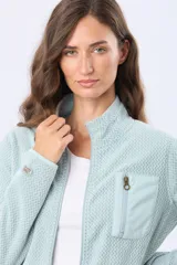 Campera de micropolar color verde agua con textura en zig zag. Presenta cuello alto, cierre frontal completo y un bolsillo superior con cierre. Diseño liviano y térmico.