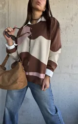 Sweater de punto con diseño de bloques de color en tonos chocolate, rosa y beige, de corte oversize y cuello redondo.