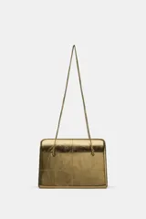 Bolso de hombro de formato rígido en piel metalizada color dorado. Presenta un diseño con pespuntes decorativos, triple compartimento interno y cierre principal mediante imán. Incluye doble asa de hombro en cadena metálica.