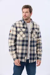 Campera leñadora de viyela a cuadros en tonos beige y azul oscuro, con interior forrado en corderito, cierre frontal con botones y dos bolsillos con solapa en el pecho.