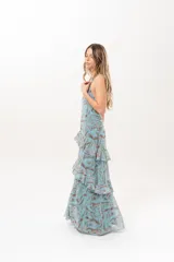 Vestido largo celeste con estampado abstracto en tonos marrones, escote halter con abertura en el frente y volados escalonados en la falda.