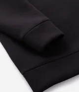 Buzo masculino de cuello alto con cierre frontal parcial, manga larga y puños ajustados. Confeccionado en tejido técnico de tacto suave.