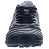 Championes de fútbol Umbro modelo Touch TF, diseñados para cancha de césped sintético. Presentan un diseño bicolor en blanco y negro, con el logo de la marca en el lateral y lengüeta. Cuentan con cierre de cordones y suela de goma con relieve para mayor tracción.