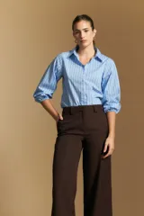 Pantalón de vestir negro de corte ancho y tiro alto, con silueta fluida y diseño minimalista.