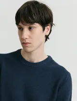 Sweater de punto con escote redondo, confeccionado en algodón con textura de punto fantasía en cuerpo y mangas, y terminaciones en punto canalé en cuello y puños.