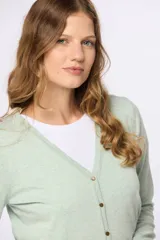 Saco tejido fino de hilo de algodón color beige, con cuello en V, cierre frontal con botones y puños acanalados.