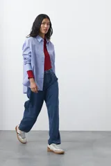 Jean de corte barrel con silueta curva y volumen controlado, de tiro medio y color negro. Presenta un diseño que se ensancha en la pierna y se ajusta levemente en el bajo, con cierre frontal y bolsillos laterales.