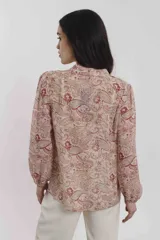 Blusa estampada con motivos cachemira en tonos crudo y rojo, con cuello mao y cierre frontal con botones.