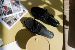 Mocasines de cuero color marrón oscuro con cordones y suela de goma.