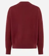 Buzo de tricot con cuello redondo y puños ajustados. Presenta un diseño de calce holgado y tejido de punto liso.