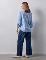 Camisa de lino color beige de la marca Dash, con cuello camisero, cierre frontal con botones, manga larga regulable con presilla y un bolsillo aplicado en el pecho.