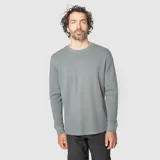 Buzo de cuello redondo con textura waffle, manga larga y puños elásticos.