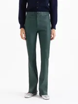 Pantalón de cuero ovino elastizado en color verde oscuro, con silueta levemente oxford, cierre metálico, botón jeanero y bolsillos delanteros y traseros.