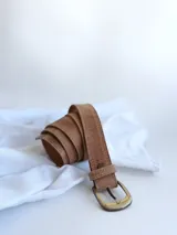 Cinto de cuero color camel con hebilla metálica dorada.