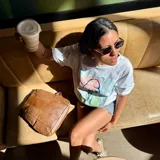 Remera blanca de corte holgado con estampa frontal artesanal de una medusa en tonos pasteles. Presenta cuello redondo y mangas cortas.