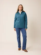 Sweater de polar con medio cierre frontal, cuello alto y mangas largas. Presenta un diseño liso en color azul petróleo con un pequeño logo bordado en el pecho.