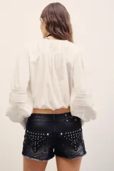 Short de denim negro con efecto desgastado, diseño de tiro bajo y dobladillo deshilachado.