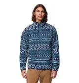 Buzo de polar Columbia con diseño estampado geométrico en tonos azules. Presenta cuello alto con cierre frontal de botones a presión, bolsillo lateral con cierre en el pecho y logo de la marca bordado.