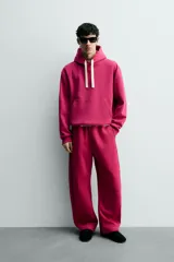 Pantalón jogger relaxed fit color bordó, confeccionado en tejido con algodón e interior forrado en tejido polar. Cuenta con cintura elástica, bolsillos frontales, bolsillos traseros de vivo y detalle de costura frontal en las perneras.