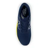 Championes de running New Balance modelo Evoz V3, color azul marino con detalles en amarillo y celeste. Presentan entresuela Fresh Foam X para máxima amortiguación y suela de goma integrada.