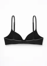 Soutien de microfibra negro, sin costura, con copa preformada y aro. Los breteles son ajustables y presentan un patrón de puntos blancos.
