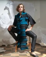 Bufandón de lana merino afieltrada color azul y negro, formado por piezas horizontales unidas que generan una textura continua.