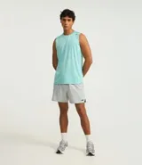 Musculosa deportiva masculina color beige, con cuello redondo y estampado sutil de líneas. Presenta recortes en los hombros y está confeccionada con tecnología Dry para mayor transpirabilidad.