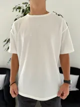 Remera oversize de tejido waffle en color blanco, con cuello redondo y mangas cortas.