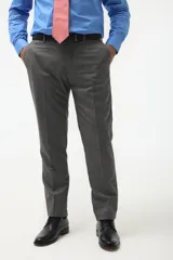 Ambo formal de corte clásico compuesto por saco de dos botones con solapa de muesca y pantalón de vestir a juego, confeccionado en tejido gris de textura fina.