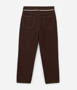 Pantalón masculino negro de corte baggy, confeccionado en sarga de algodón. Presenta detalles de costura, cierre tradicional de botón y cremallera, y un cordón blanco para ajustar la cintura.