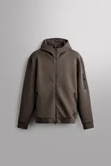 Campera canguro de Zara Athleticz, modelo relaxed fit, confeccionada en tejido técnico compacto elástico con mezcla de algodón en color azul marino. Cuenta con cuello subido con capucha, manga larga con bolsillo lateral con cierre, bolsillos frontales con cierre y acabado termofijado, cierre frontal de doble dirección y logo estampado en el bajo.