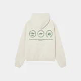 Hoodie de corte oversized color arena, con capucha y bolsillo tipo canguro. Presenta un diseño estampado en la espalda con tres círculos gráficos y texto en color verde.