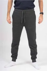 Pantalón de jogging unisex de felpa, color verde oscuro, con cintura elástica con cordón de ajuste y puños elásticos en los tobillos.