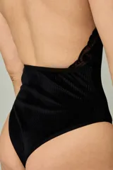 Body negro confeccionado en terciopelo acanalado, con cuello alto, diseño sin mangas y detalles de encaje a lo largo de las sisas y los hombros.
