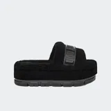 Sandalias UGG Fluffita Clear color negro, con plataforma plana y suela translúcida. Tienen una correa ajustable y plantilla contorneada. Forradas con mezcla de lana UGGplush™ y logo gráfico.
