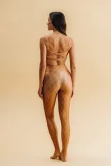 Top deportivo color bronce/naranja con estampado geométrico sutil, escote cuadrado y espalda torneada. Tiene forro y bolsillo para copas removibles.