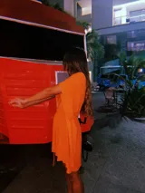 Poncho tipo blusa color naranja con vuelos laterales y cuerdita de hilo. Tejido de punto con hilado italiano de alta calidad. Confeccionado en rayón y viscosa con lurex.