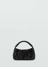 Bolso negro pequeño con diseño acolchado y doble asa corta.