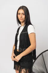 Chaleco marrón de gamuza con flecos y tachas plateadas.
