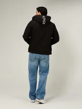 Campera soft shell de hombre marca Tommy Hilfiger, color negro, con capucha, cierre de cremallera frontal y bolsillos con cierre en el pecho y laterales.