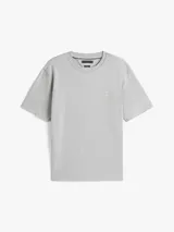 Remera de punto de algodón moteado color gris, con cuello redondo y escudo tonal con el monograma TH bordado en el pecho. Presenta un corte amplio y cinta distintiva en el interior del cuello.