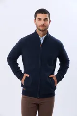 Campera tejida de lana color azul marino, con cuello alto, cierre metálico frontal y bolsillos laterales. Presenta detalles en cuero y logo bordado.