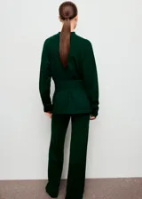 Jersey de punto fino color verde oscuro, con cuello perkins, manga larga y diseño entallado con detalle de lazo anudado en la cintura.