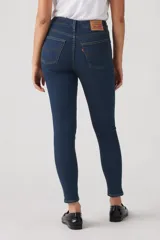Jean skinny de tiro alto color azul oscuro, con cierre de botón y cremallera, y bolsillos delanteros y traseros.